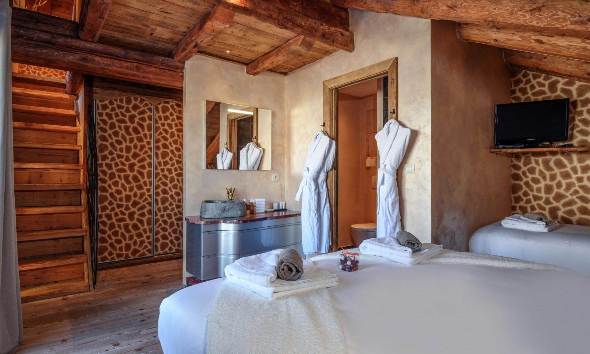 The double bedroom with an extra bed in Catered Chalet Cheval Blanc Meribel Le Raffort The double bedroom with an extra bed in Catered Chalet Cheval Blanc Meribel Le Raffort