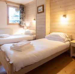 A comfortable bedroom in Chalet Le Cedre Blanc Meribel