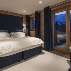 A spacious and comfortable bedroom in Chalet Le Grenier in Meribel Centre