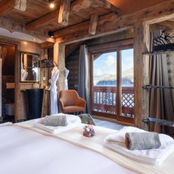 A beautiful bedroom in Catered Chalet Cheval Blanc Meribel Le Raffort