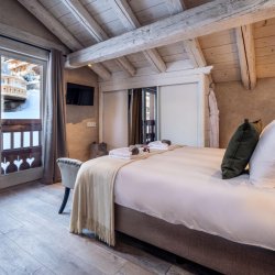 One of the elegant bedrooms in Catered Chalet Cheval Blanc Meribel Le Raffort