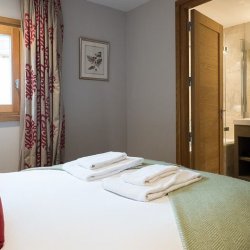 A double bedroom with ensuite bathroom in Chalet Montana in Meribel Centre