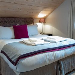 A comfortable bedroom in Chalet Montana in Meribel Centre