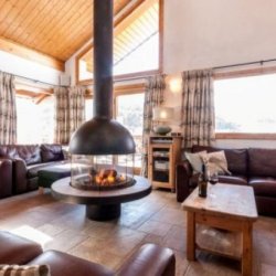 The living room with fireplace in Chalet Virage Meribel Centre