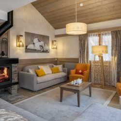An apartment Living area with a fireplace in Residence L'Hevana Meribel