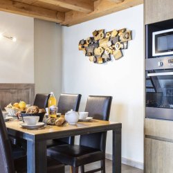 The Dining and kitchen area in a 6 person apartment  in the Chalet des Neiges Hermine apartments in Val Thorens