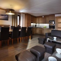 The Living, dining and kitchen area in a 12 person apartment in the Chalet des Neiges Hermine apartments in Val Thorens